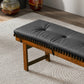 Modern wooden bench with black tufted cushion on textured rug, FredCo International furniture