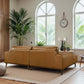 Modern living room with tan leather sofas, indoor plants, and arched windows at FredCo International
