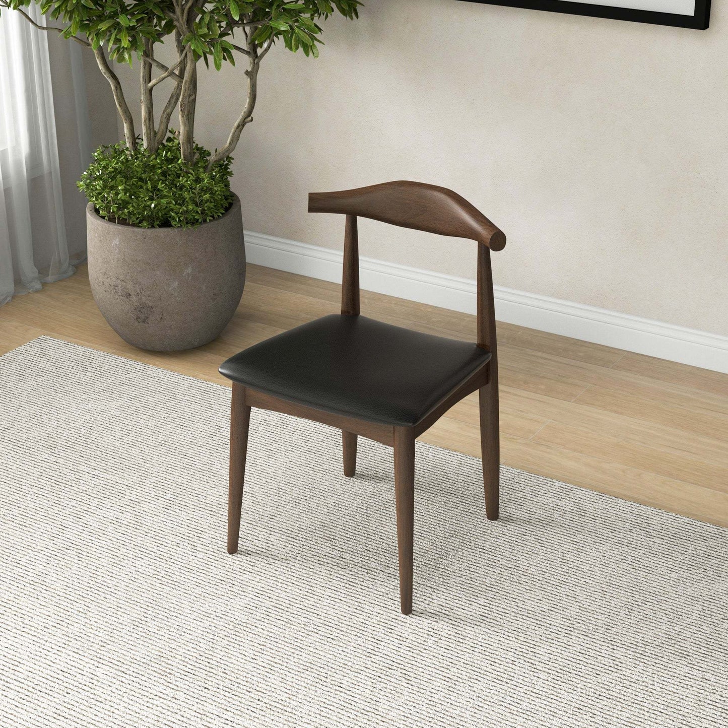 Mid-century modern wood and black leather dining chair in stylish home interior