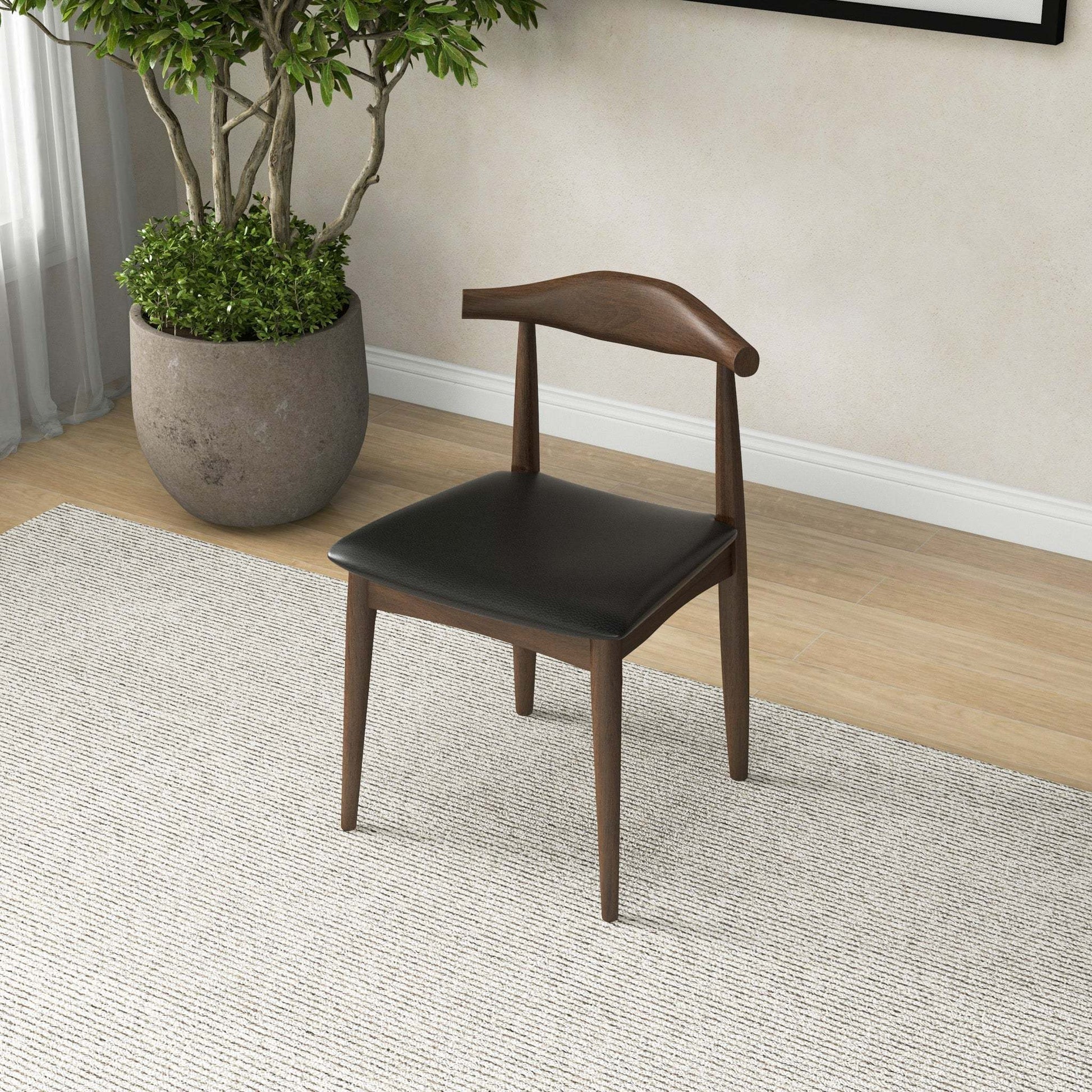Mid-century modern wood and black leather dining chair in stylish home interior