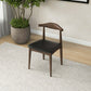 Mid-century modern wood and black leather dining chair in stylish home interior