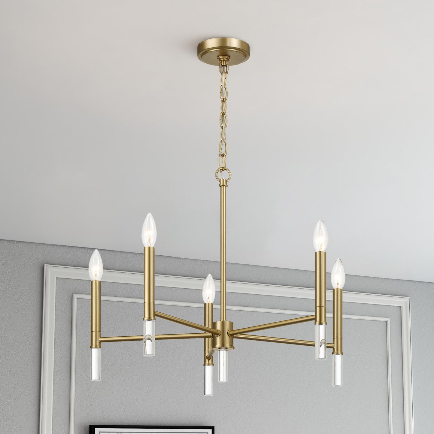 Modern gold chandelier with six candle bulbs in elegant home interior, FredCo International