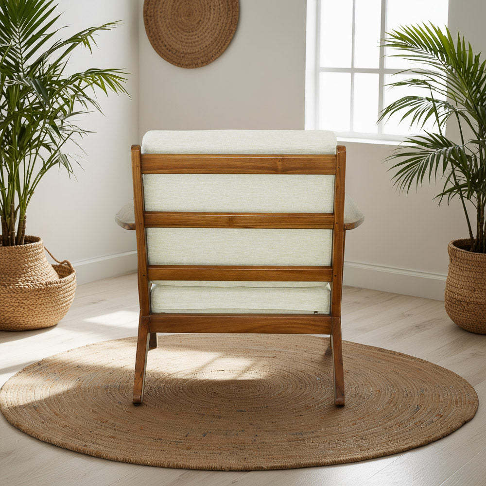 Modern wooden accent chair with ivory cushion on round jute rug in bright home interior