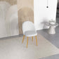 Modern white accent chair with wood legs on a neutral rug in contemporary living room