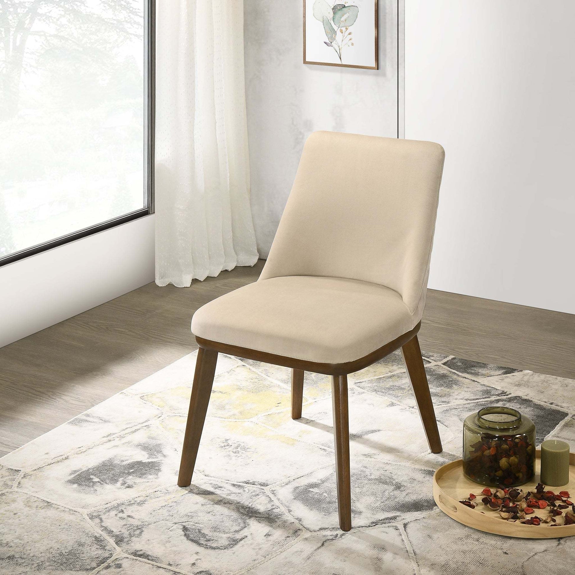 Modern beige upholstered dining chair with wooden legs on a patterned rug in a bright room