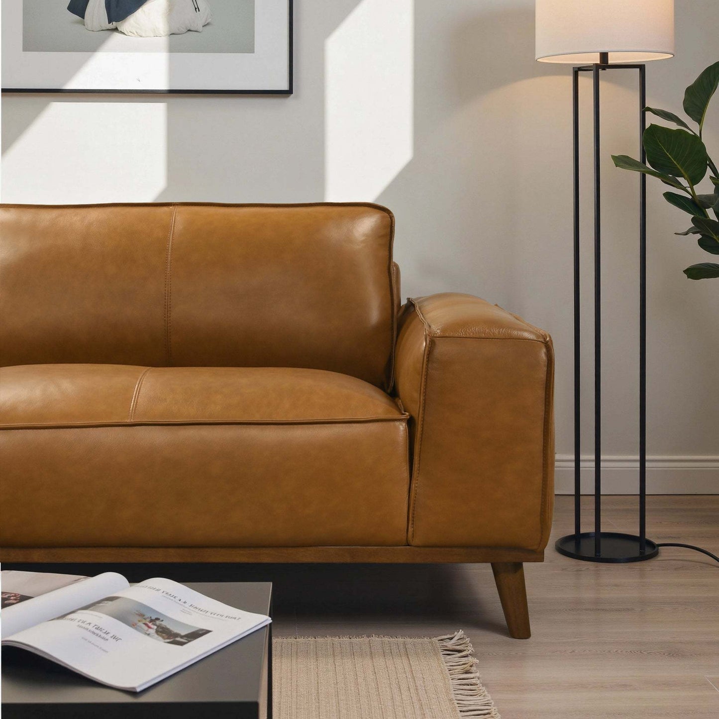 Modern brown leather sofa with floor lamp in stylish living room, FredCo International furniture