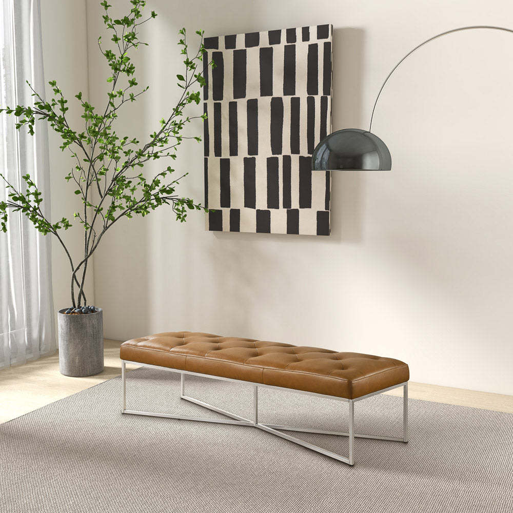 Modern living room with tufted brown bench, abstract wall art, and indoor plant from FredCo International