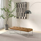 Modern living room with tufted brown bench, abstract wall art, and indoor plant from FredCo International