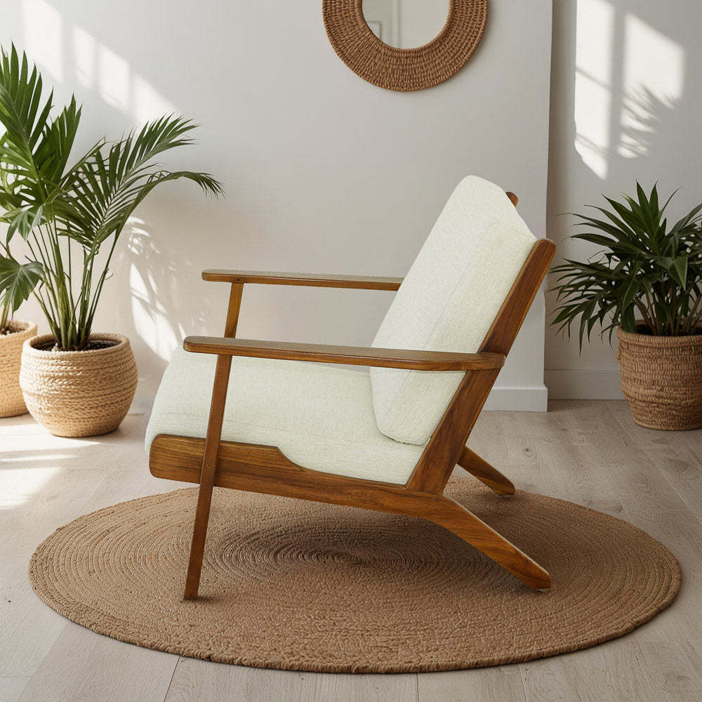 Mid-century modern wooden armchair with cream cushion on round rug, indoor plants, bright room