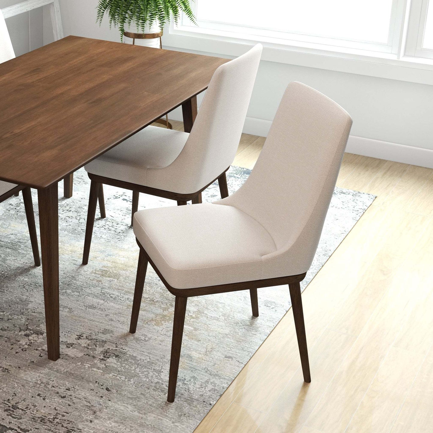 Modern wood dining table with beige upholstered chairs in a bright, contemporary home setting