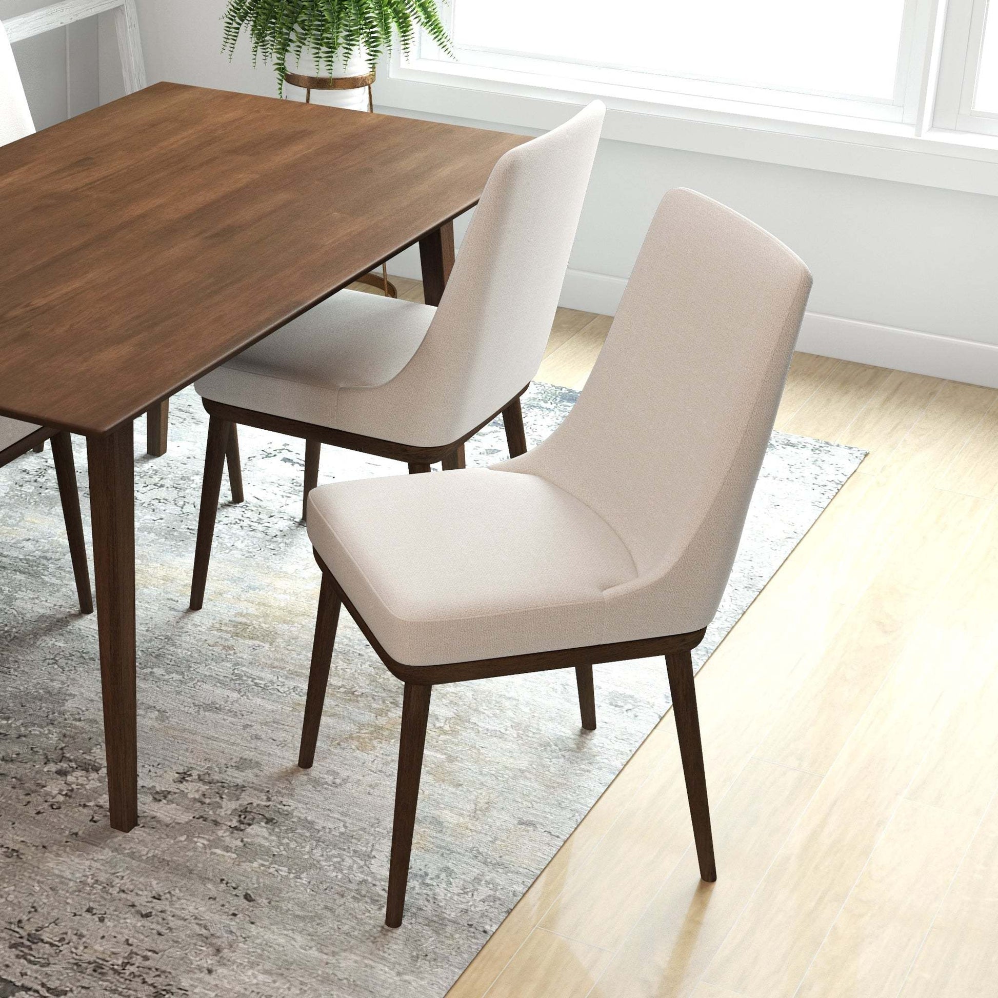 Modern wood dining table with beige upholstered chairs in a bright, contemporary home setting