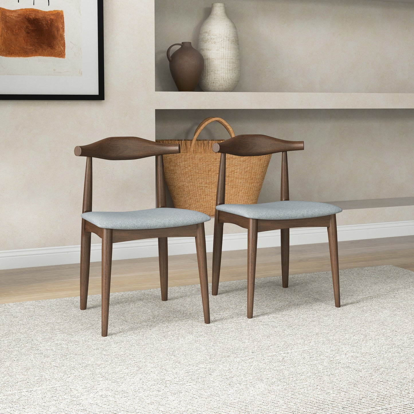 Pair of modern wooden dining chairs with light gray cushions in a stylish home setting
