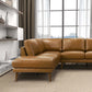 Modern tan leather sectional sofa in bright living room with large window and shelves