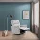 Modern light gray recliner chair in living room with blue wall, floor lamp, and wall art
