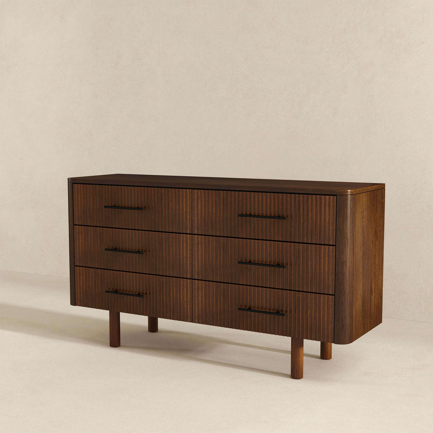 Modern dark wood dresser with three drawers, black handles, and fluted front design