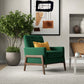 Modern living room with green accent chair, yellow pillow, potted plant, abstract wall art