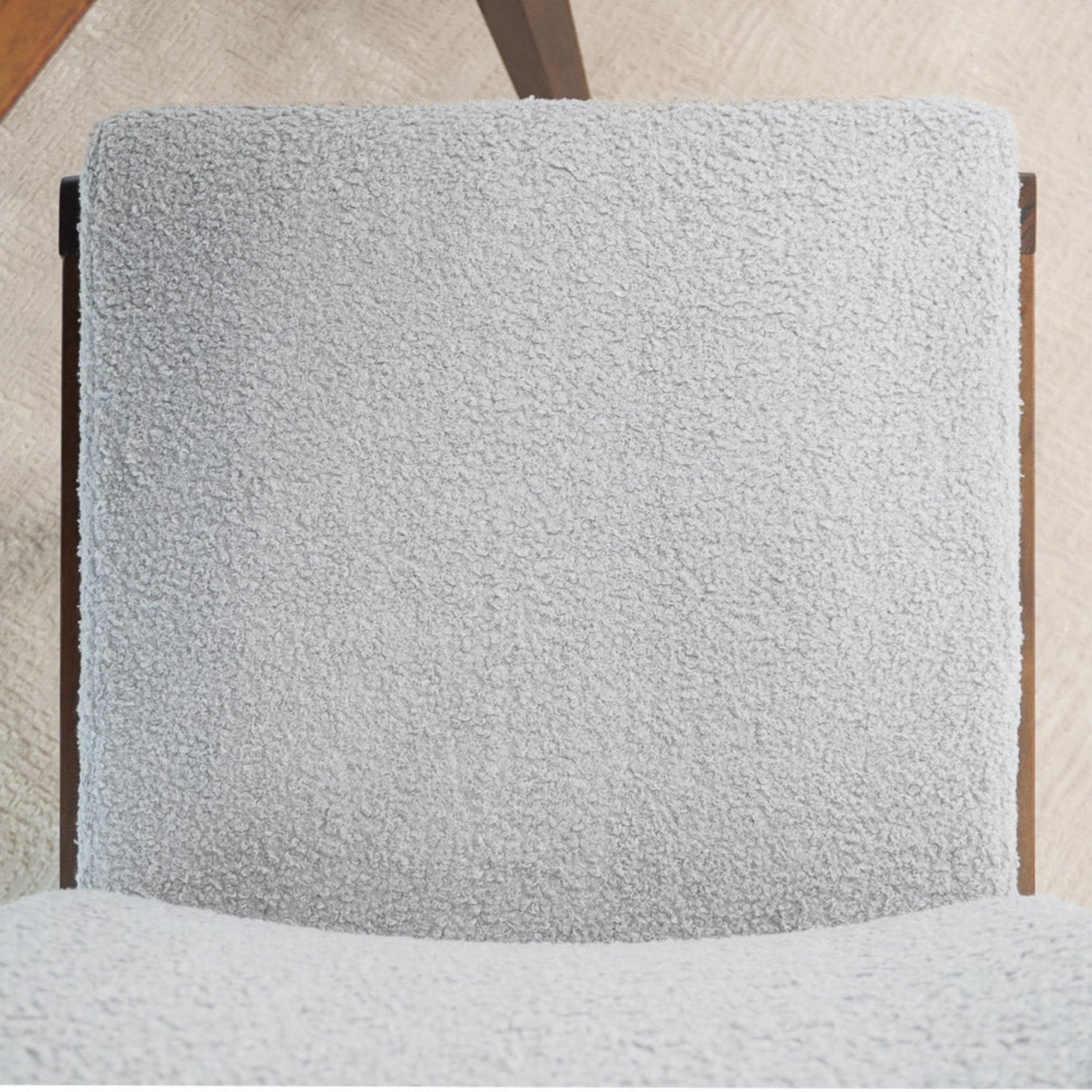 Light gray textured fabric dining chair with wooden frame on beige carpet, FredCo International