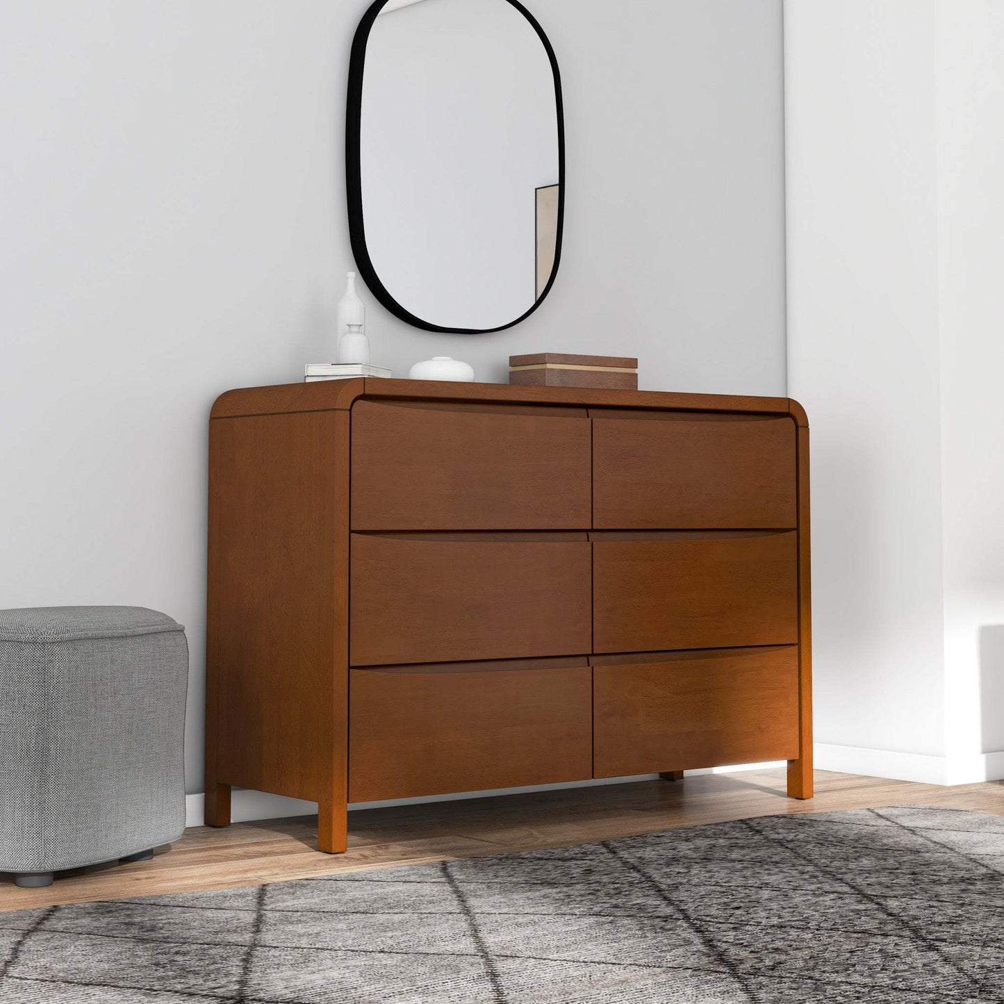 Modern wooden dresser with six drawers in a bedroom, mirror above, grey ottoman, FredCo International furniture