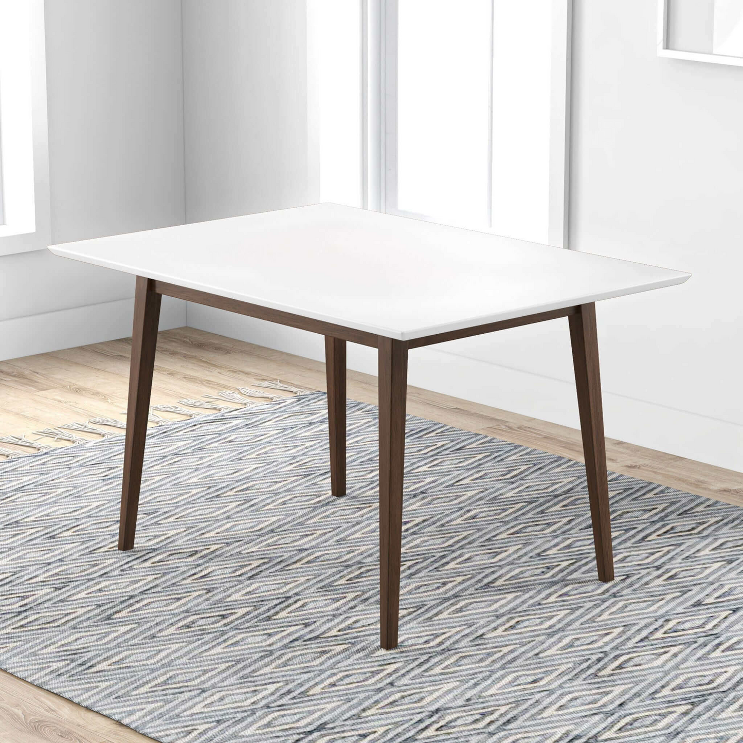 Modern square dining table with white top and wooden legs on patterned rug in bright room