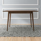 Modern wooden dining table on patterned rug, FredCo International home furniture