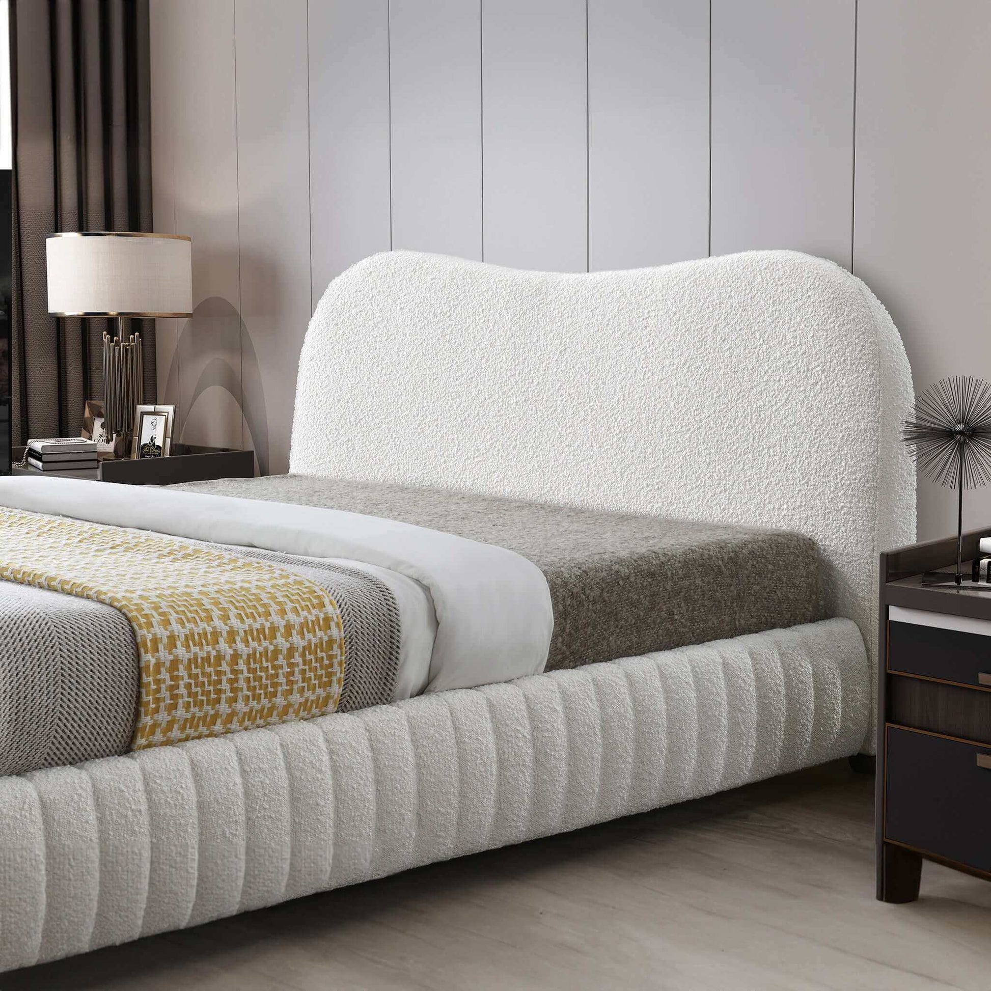 Modern white upholstered bed with textured headboard in stylish bedroom setting