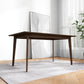 Modern wooden dining table on rug in bright room with wall art and plant, FredCo International furniture