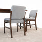 Modern dining chairs with gray upholstery and wooden frames on beige carpet, FredCo International