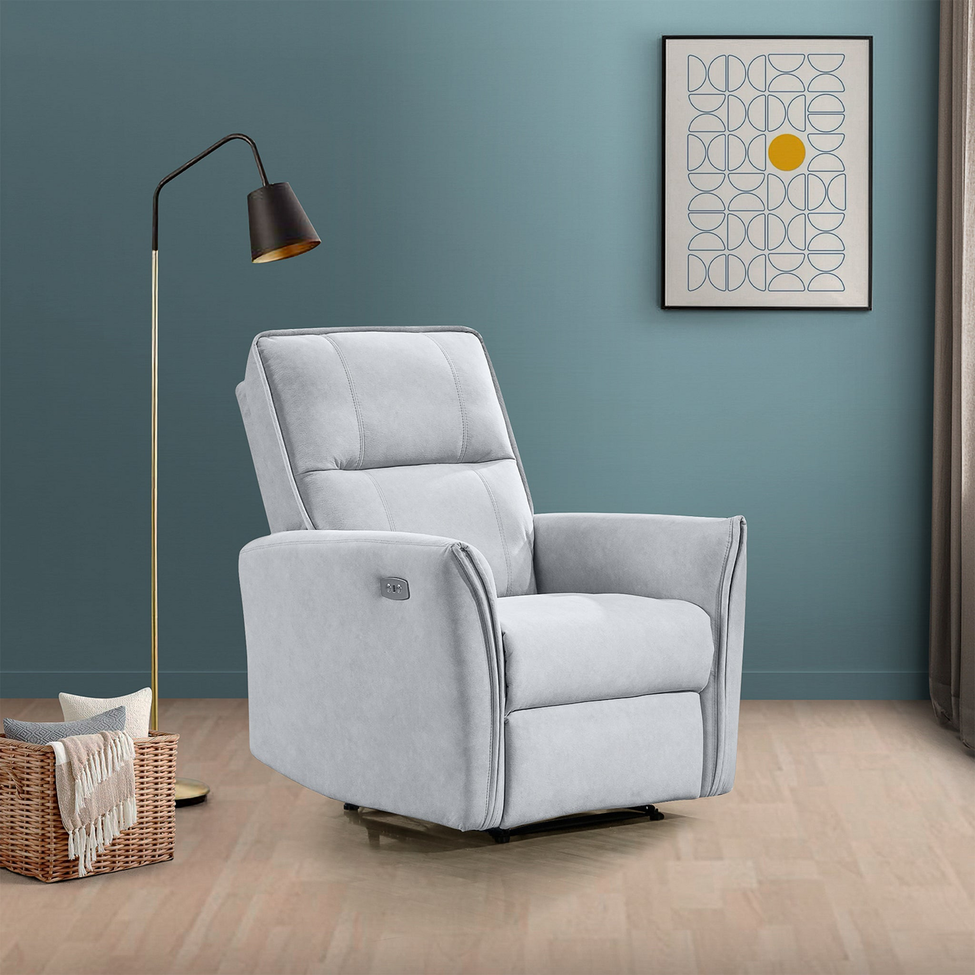 Modern light gray recliner chair in living room with blue wall, floor lamp, and abstract art