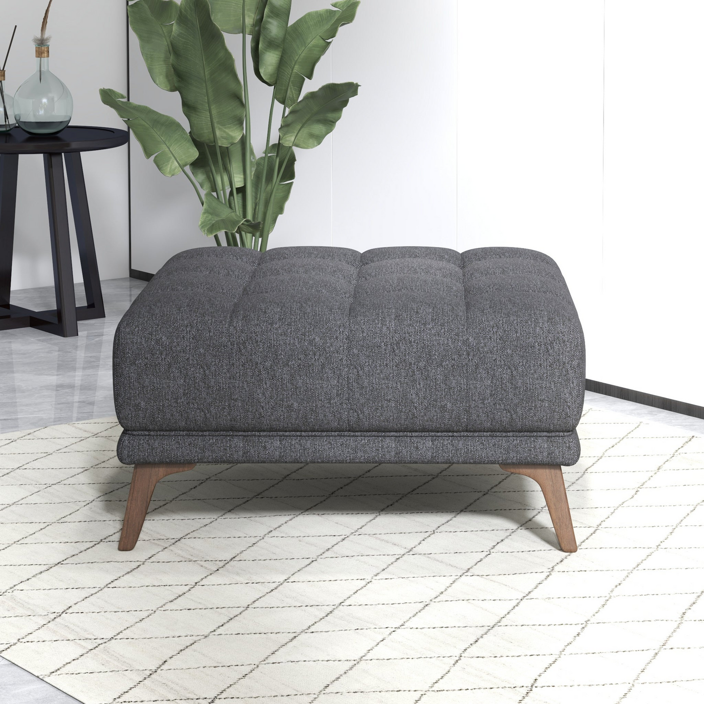 Modern gray upholstered ottoman with wooden legs on a patterned rug in a stylish living room