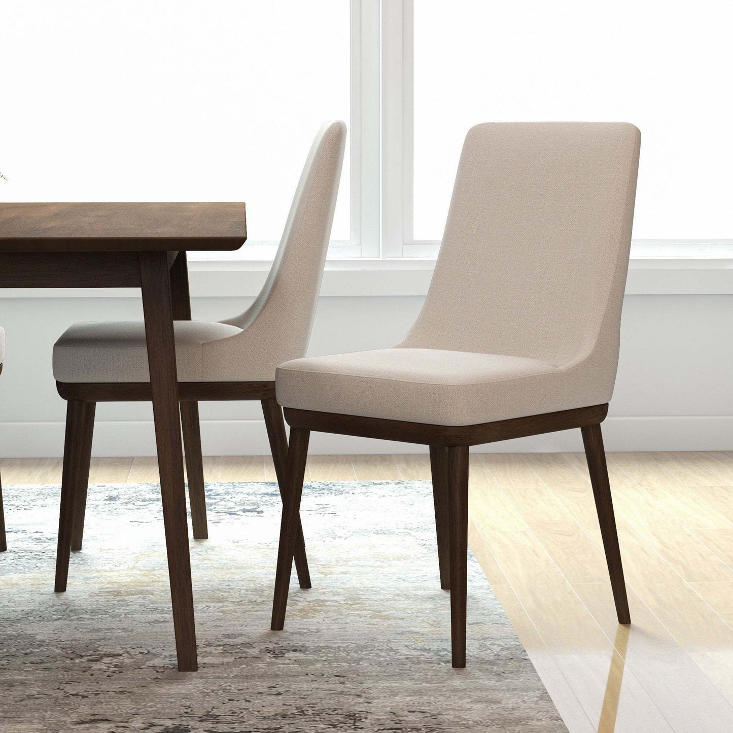 Modern beige dining chairs with wooden legs next to a wooden table in a bright room