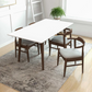 Modern dining room with white table, four wooden chairs, rug, and plant by FredCo International