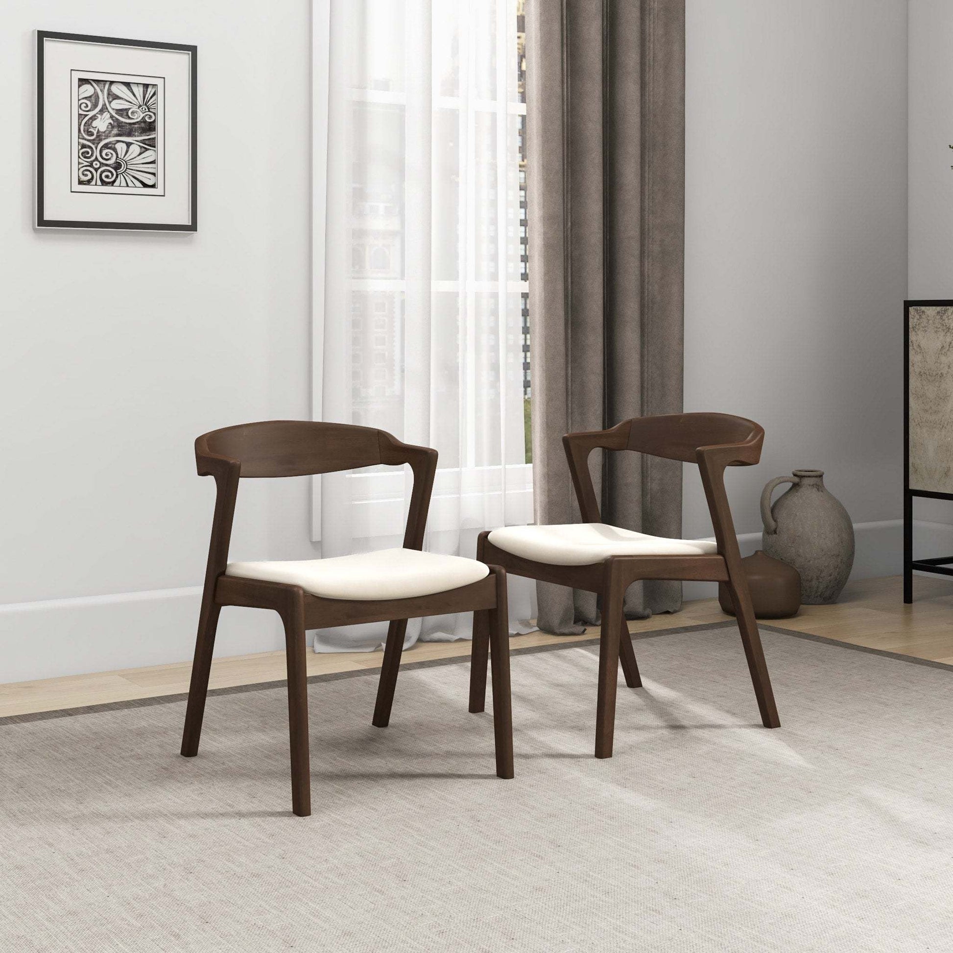 Modern wooden dining chairs with white cushions in a bright living room, FredCo International furniture