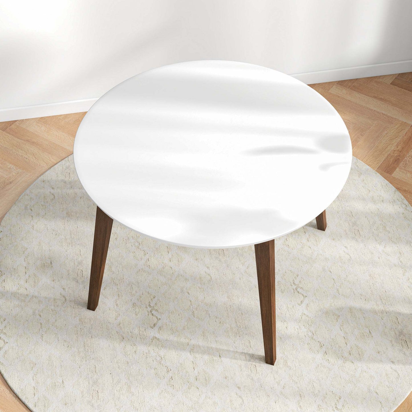 Modern round white coffee table with wooden legs on a light rug, hardwood floor, FredCo International