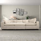 Modern beige sectional sofa in stylish living room with gallery wall, rug, and decor