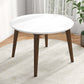 Modern round white dining table with wooden legs in bright living room on rug