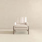 Modern beige accent chair with wood legs in minimalist setting, FredCo International furniture