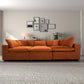 Modern living room with orange velvet sofa, gallery wall art, and neutral decor from FredCo International furniture store