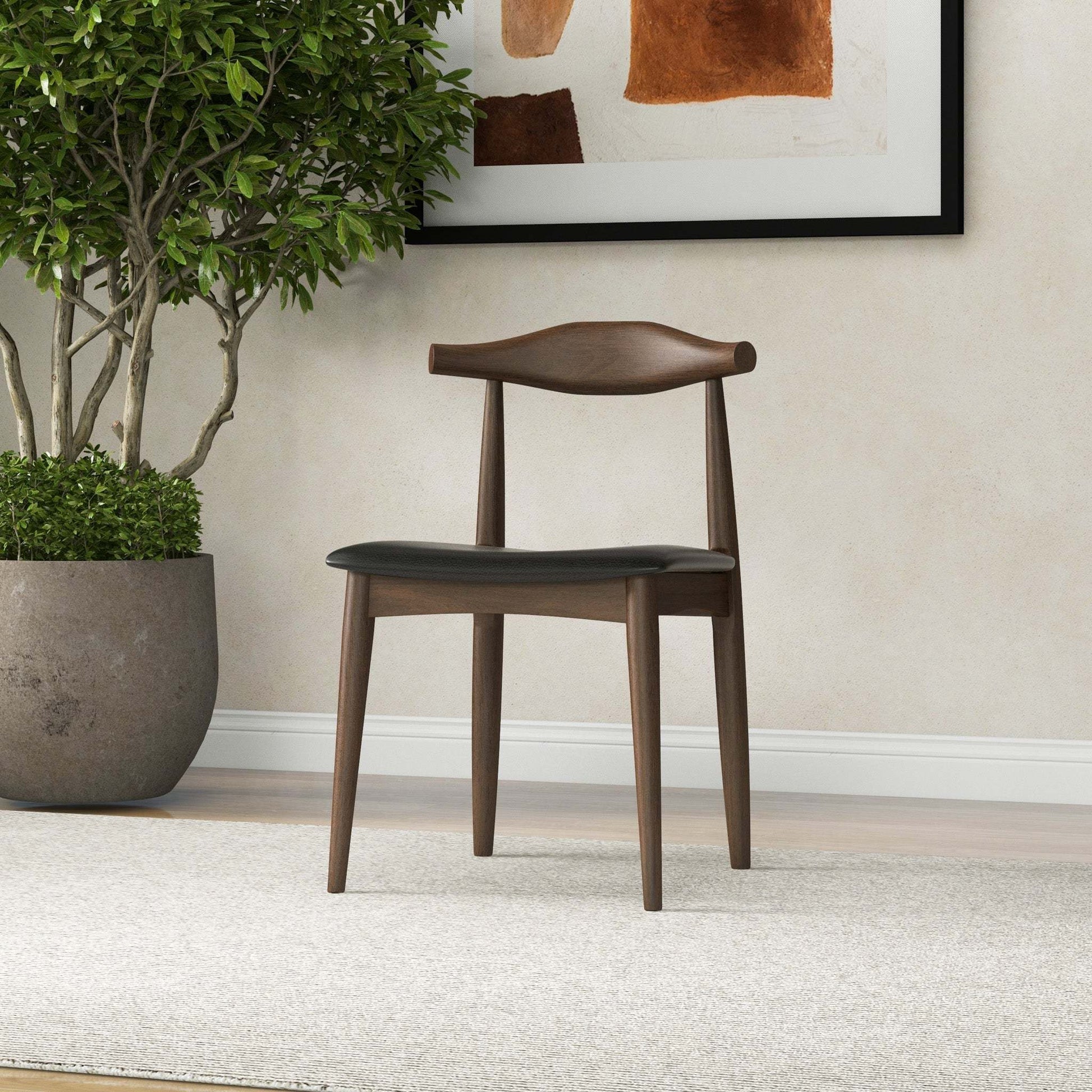 Mid-century modern wooden chair with black seat in a home interior, FredCo International furniture
