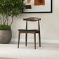 Mid-century modern wooden chair with black seat in a home interior, FredCo International furniture