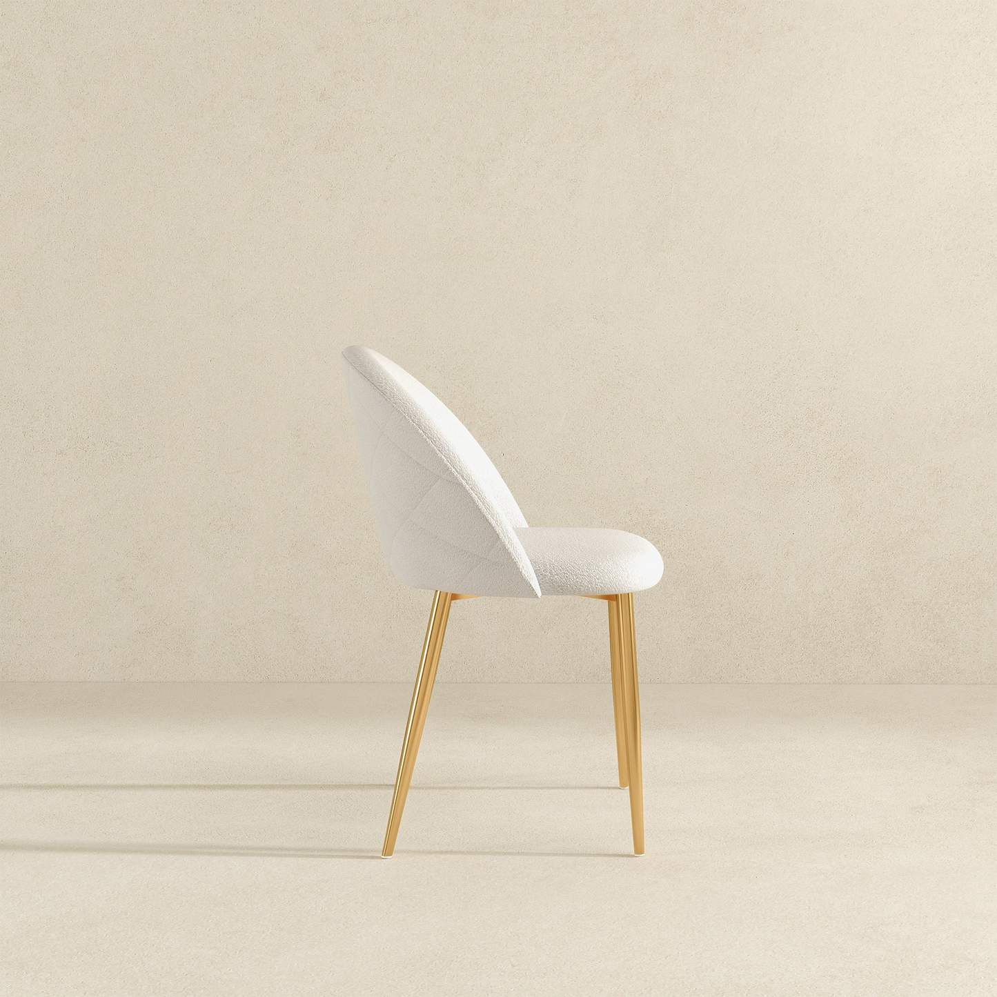 Modern white upholstered accent chair with gold legs on neutral background, FredCo International