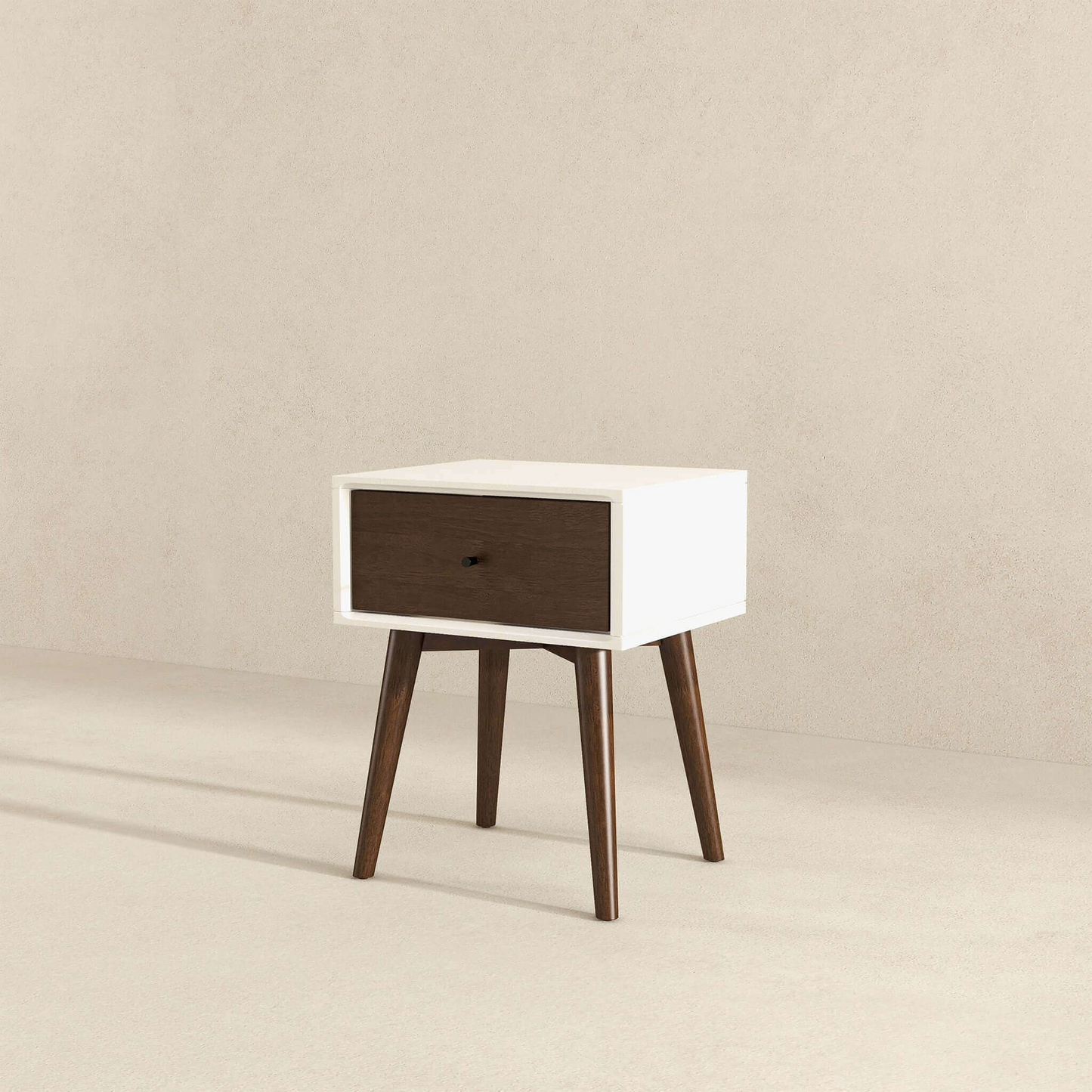 Mid-century modern nightstand with white frame, dark wood drawer, and angled legs on neutral background