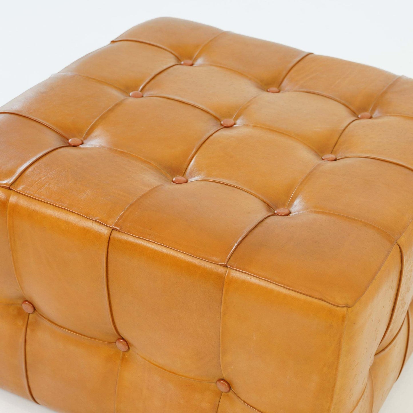 Tan tufted leather ottoman with button details, modern home furniture from FredCo International