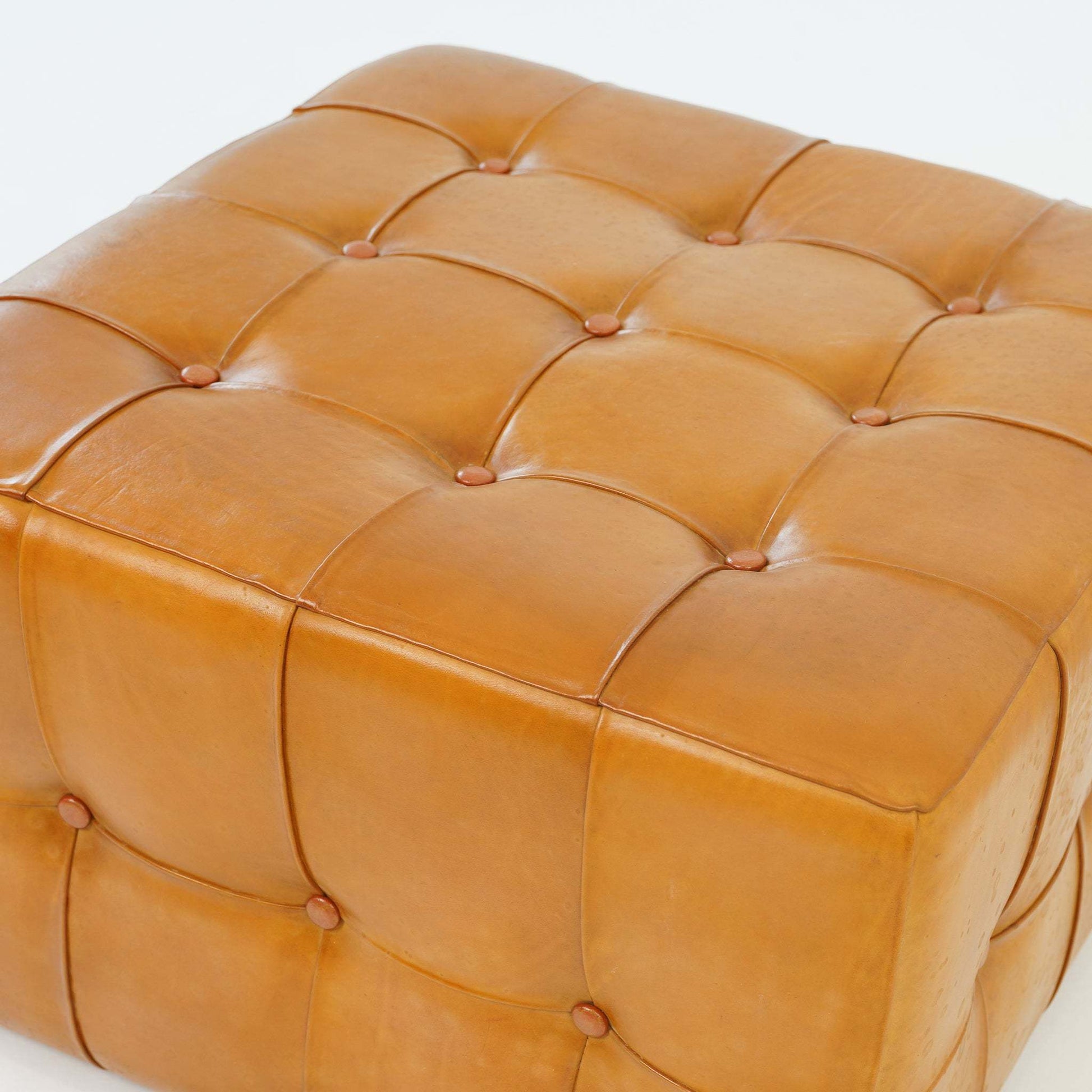 Tan tufted leather ottoman with button details, modern home furniture from FredCo International