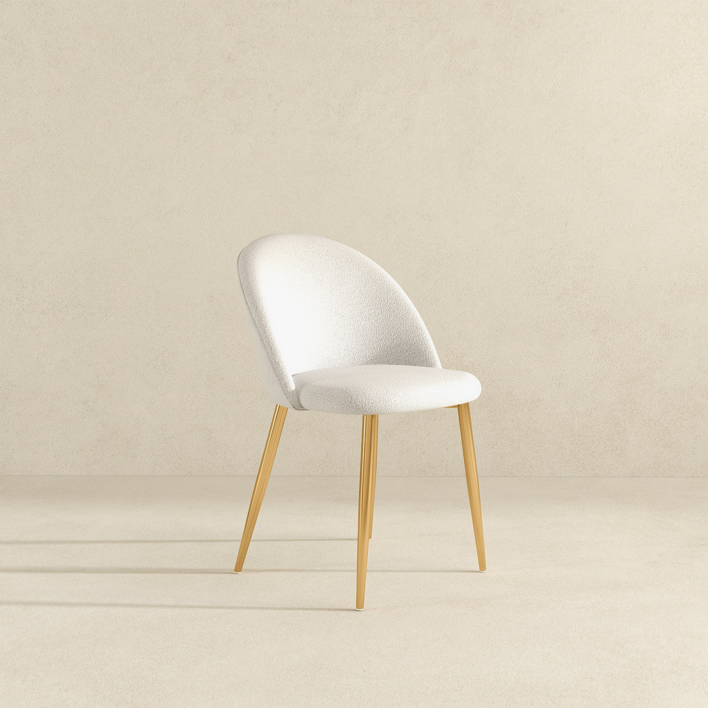 Modern white upholstered dining chair with gold legs on a neutral background, FredCo International furniture