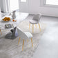 Modern dining room with marble table, white chairs, and fruit bowl, FredCo International furniture