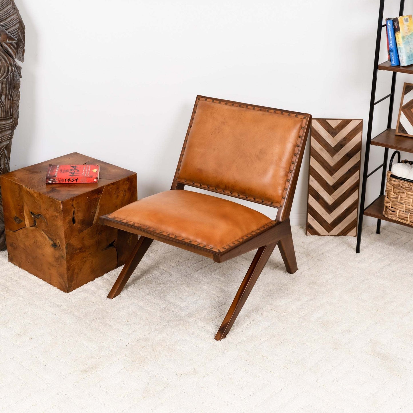 Modern tan leather accent chair with wood frame in stylish living room setting