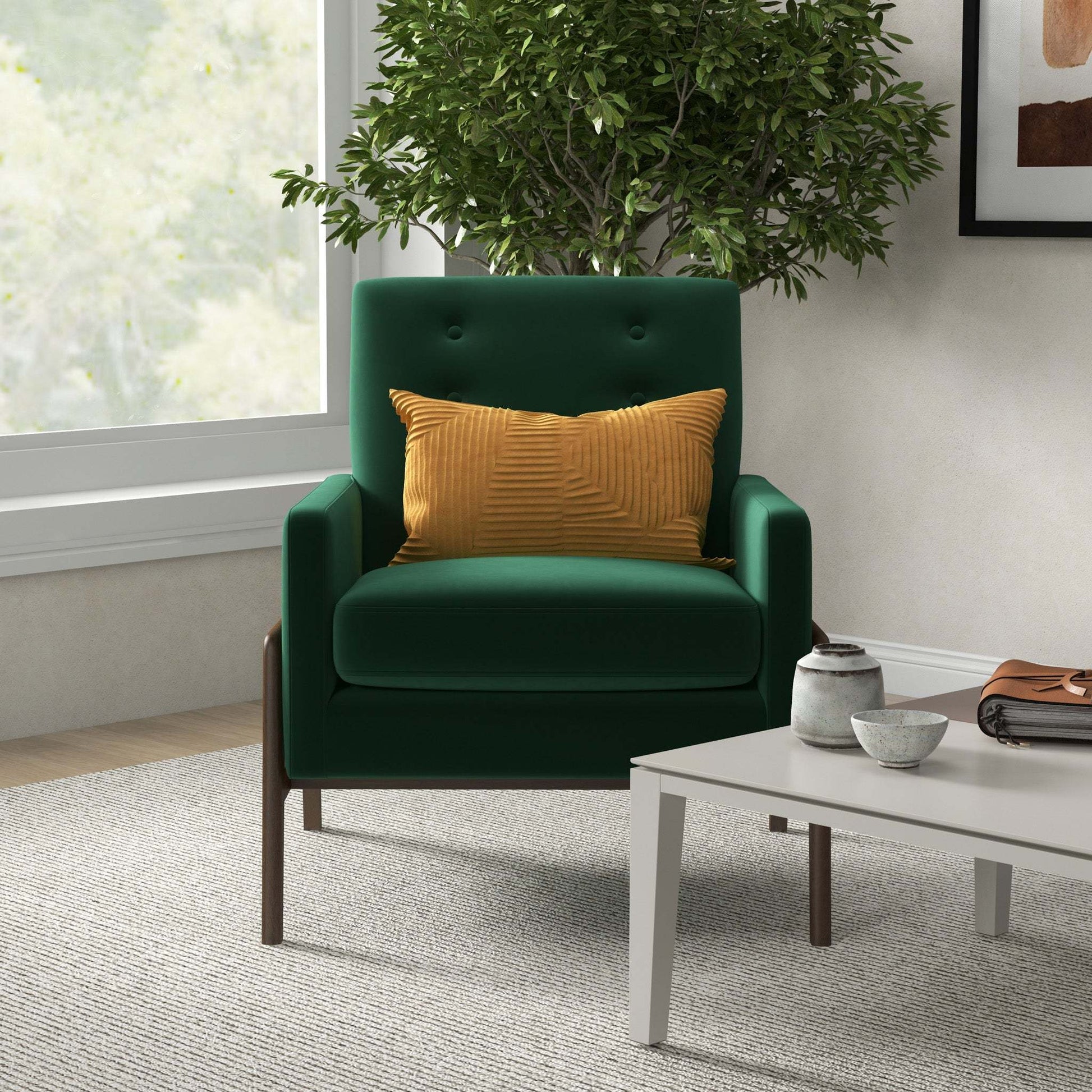 Modern green armchair with gold pillow in cozy living room, beside coffee table and indoor plant