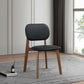 Modern black and wood accent chair on patterned rug in bright living room, FredCo International