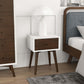 Mid-century modern nightstand with white and wood finish beside bed and lamp, FredCo furniture