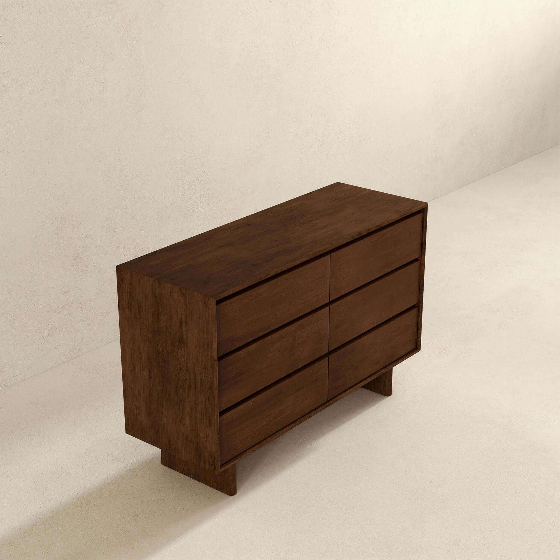 Modern dark wood dresser with six drawers in a minimalist room, FredCo International furniture